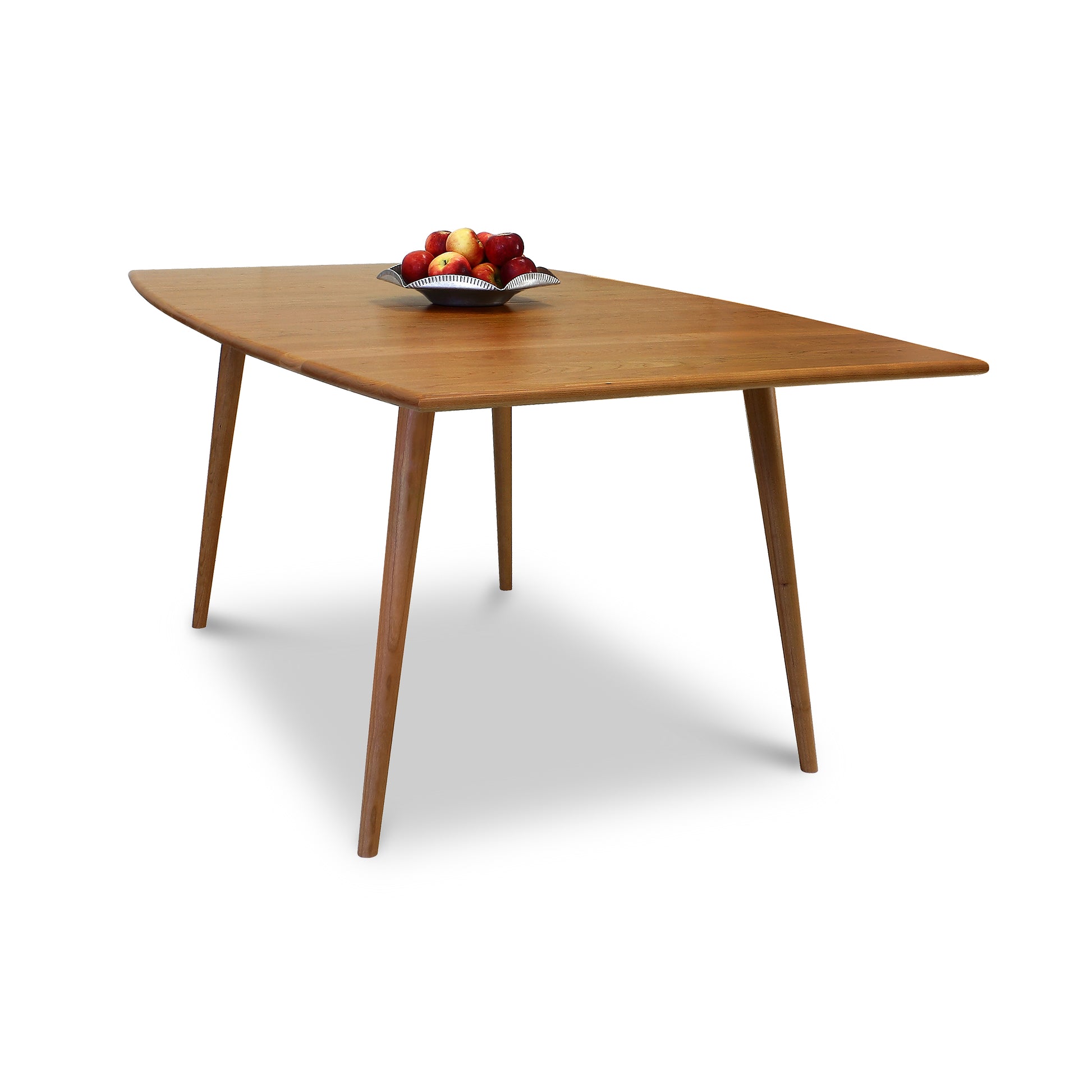 An Addison Solid Boat-Top Dining Table made of natural cherry wood, adorned with a bowl of apples, manufactured by Lyndon Furniture.