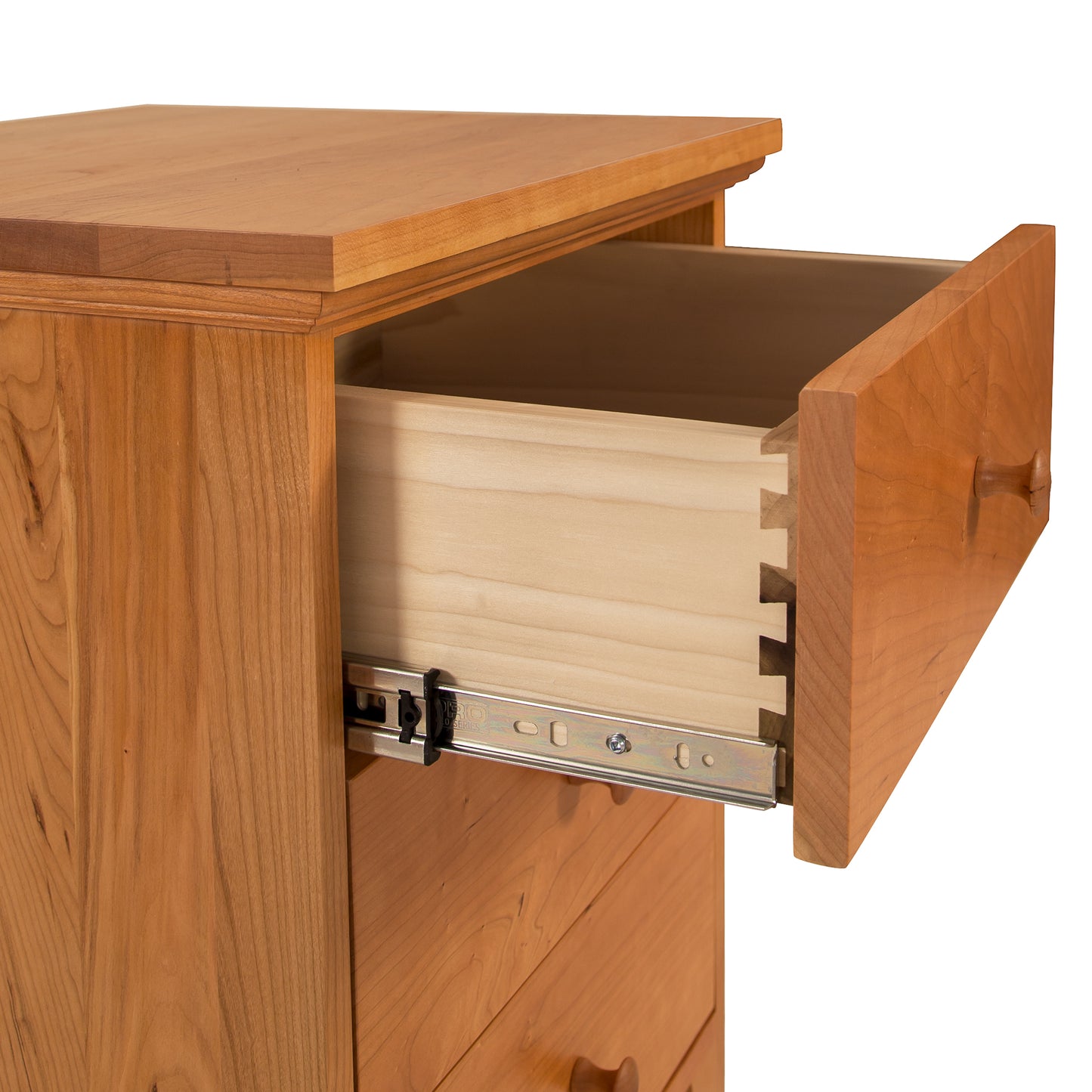 The handcrafted solid wood drawer of a Lyndon Furniture American Country 3-Drawer Nightstand is open.