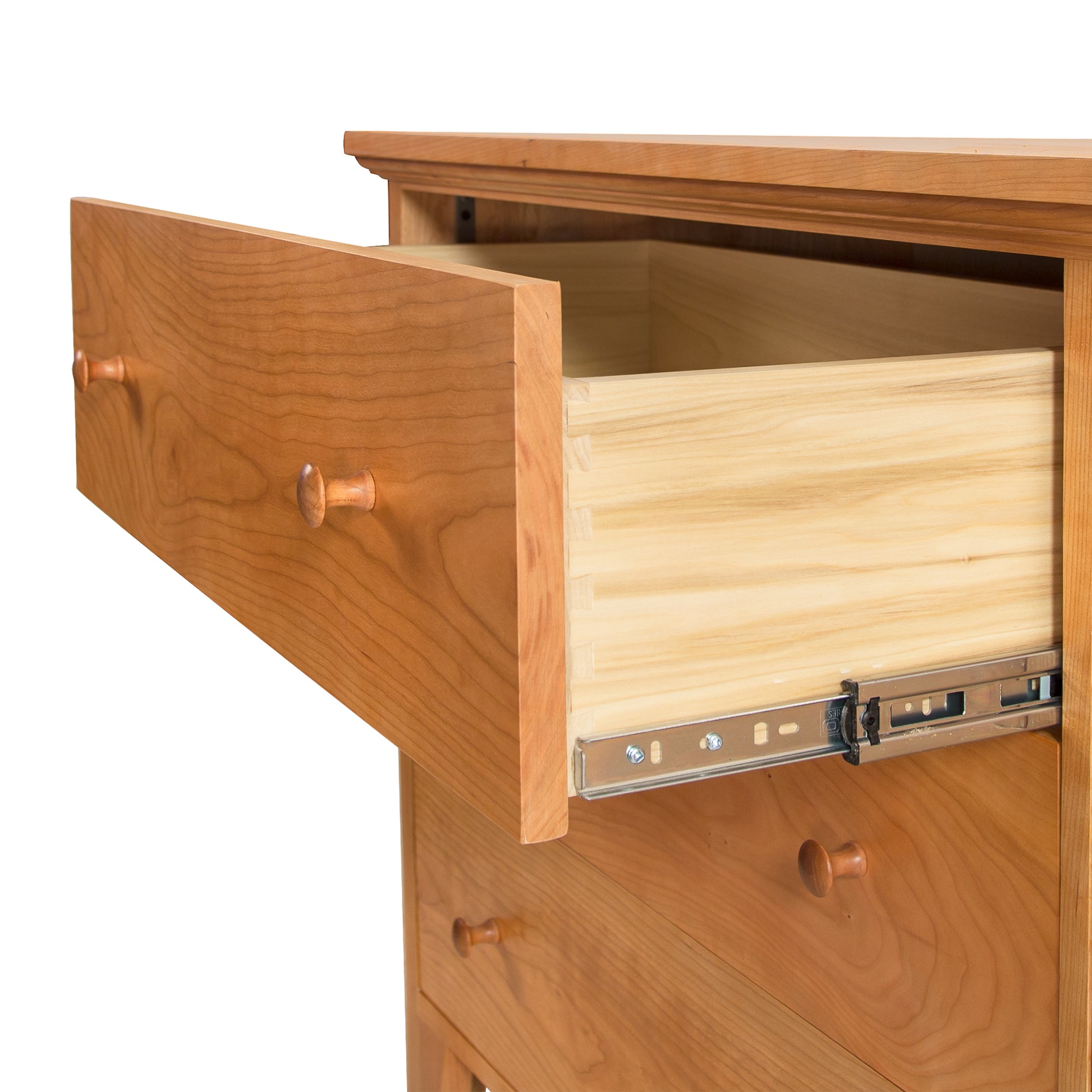 An open drawer of a Lyndon Furniture American Country 6-Drawer Dresser - Floor Model, showcasing its smooth, light-colored interior and sturdy dovetail joints, with a focus on the metal sliding mechanism.