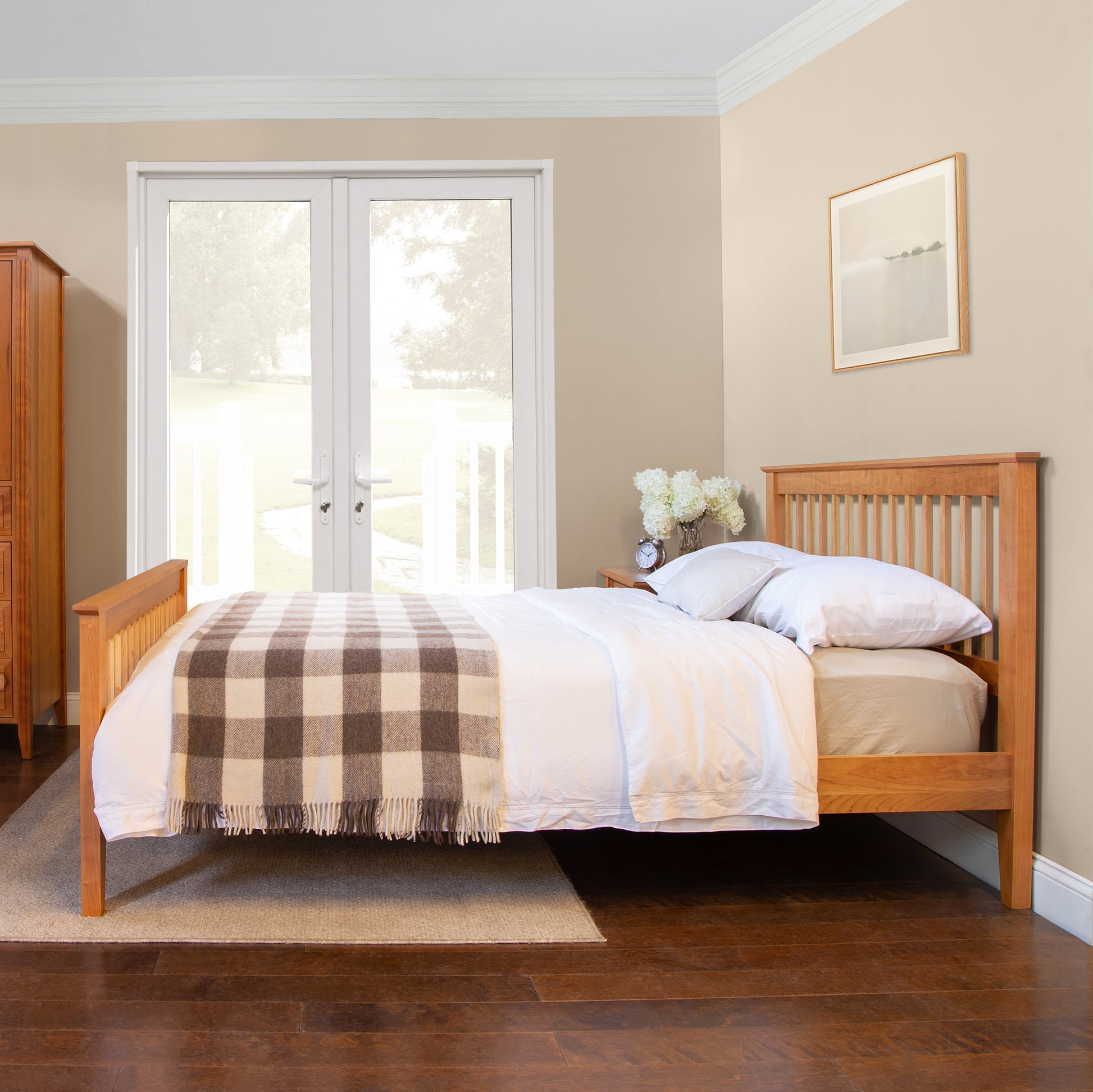 Lyndon Furniture American Mission Bed featuring white bedding and a plaid blanket, showcasing handcrafted wood design.