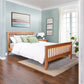 A high-quality Lyndon Furniture American Mission Bed in a bedroom with blue walls.