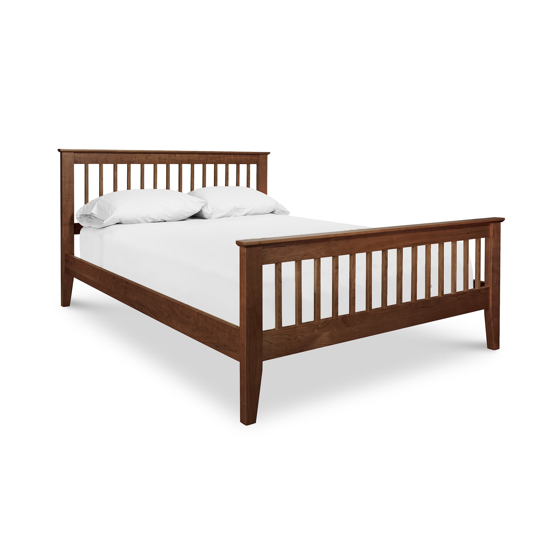 A high-quality Lyndon Furniture American Mission Bed with a white sheet on it.