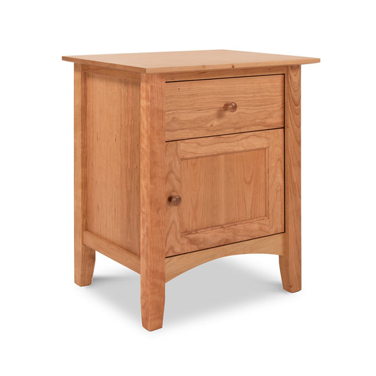 A small Maple Corner Woodworks American Shaker 1-Drawer Nightstand with Door, meticulously crafted in Vermont using natural cherry wood.