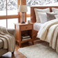 Maple Corner Woodworks American Shaker 1-Drawer Enclosed Shelf Nightstand with books and lamp, showcasing fine craftsmanship and solid wood quality.