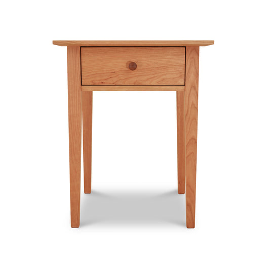 American Shaker 1-Drawer Nightstand crafted from solid maple by Maple Corner Woodworks. This classic, small wooden table features straight legs, a flat top, and a single center drawer with a natural light finish that emphasizes its timeless elegance. Perfect for those seeking high-quality Vermont-made shaker furniture.