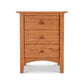 A Maple Corner Woodworks American Shaker 3-Drawer Nightstand with round knobs and curved legs, isolated on a white background.