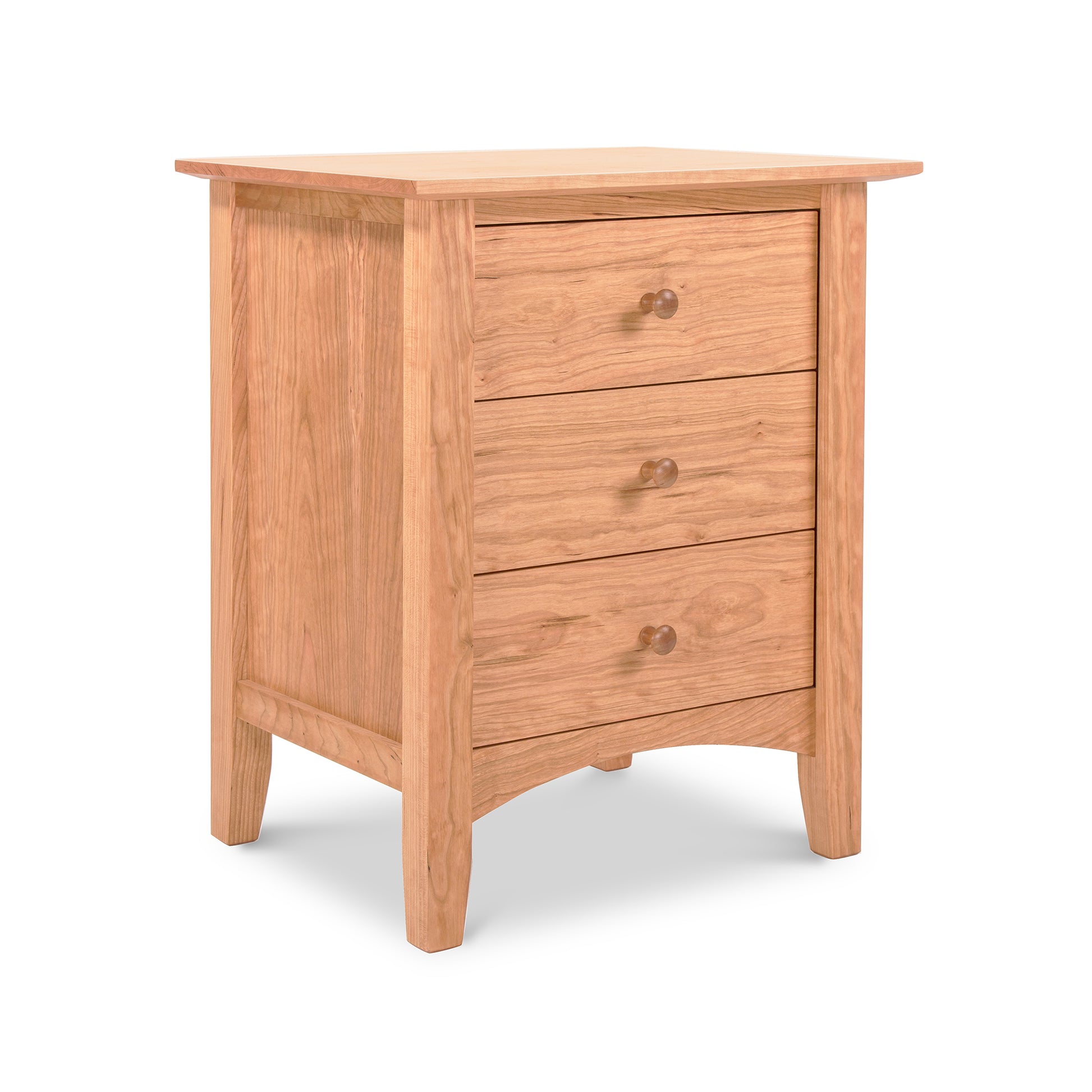 A Maple Corner Woodworks American Shaker 3-Drawer Nightstand, featuring three drawers each with a round knob, and standing on four sturdy legs. The piece, displaying Vermont craftsmanship, is set against a plain white background.