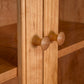 Detail view of handcrafted round wooden knobs on the American Shaker Bookcase by Maple Corner Woodworks, made from sustainable hardwoods.