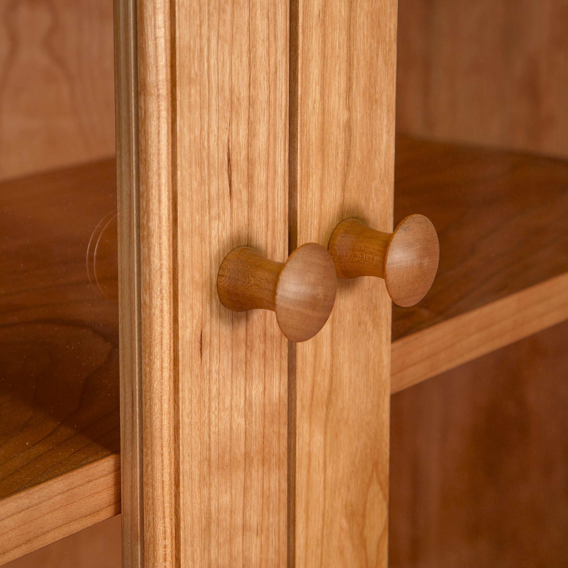 Detail view of handcrafted round wooden knobs on the American Shaker Bookcase by Maple Corner Woodworks, made from sustainable hardwoods.