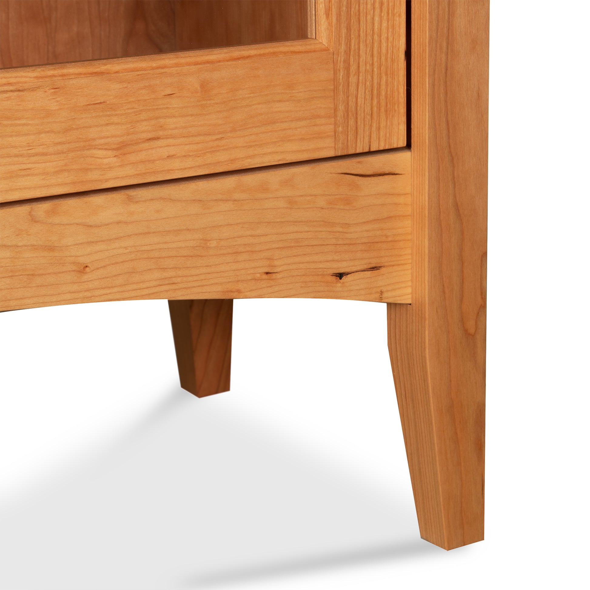 Detail of handcrafted Shaker bookcase by Maple Corner Woodworks, highlighting solid hardwood leg and lower frame. American made furniture quality.