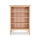 An American Shaker Bookcase from Maple Corner Woodworks, made of sustainably harvested hardwoods, placed on a white background.