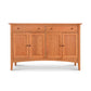 The American Shaker Large Sideboard by Maple Corner Woodworks is a stunning piece showcasing Vermont craftsmanship with its two drawers and double doors. Made from solid hardwood with a smooth finish, this sideboard stands on four straight legs and features light-colored wood in the classic Shaker style.