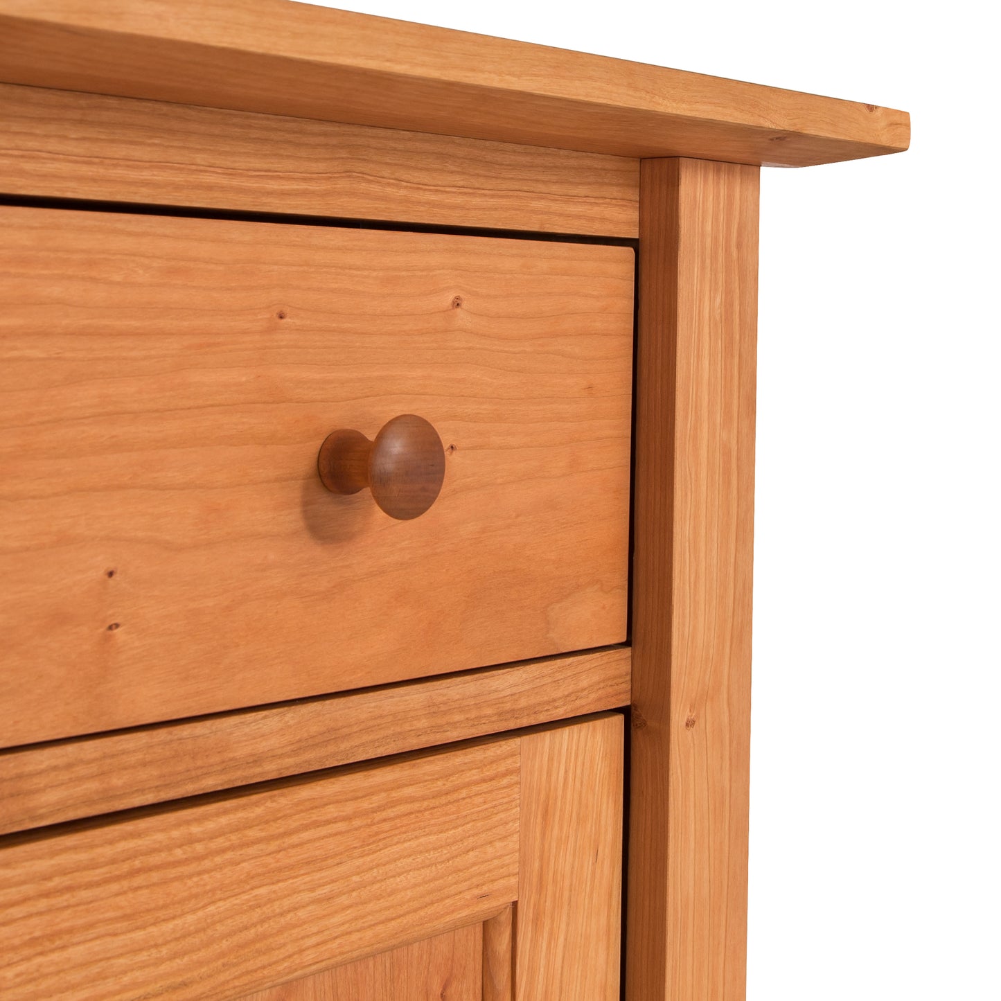 A close up of a wooden American Shaker Sideboard with a knob showcasing Maple Corner Woodworks craftsmanship.