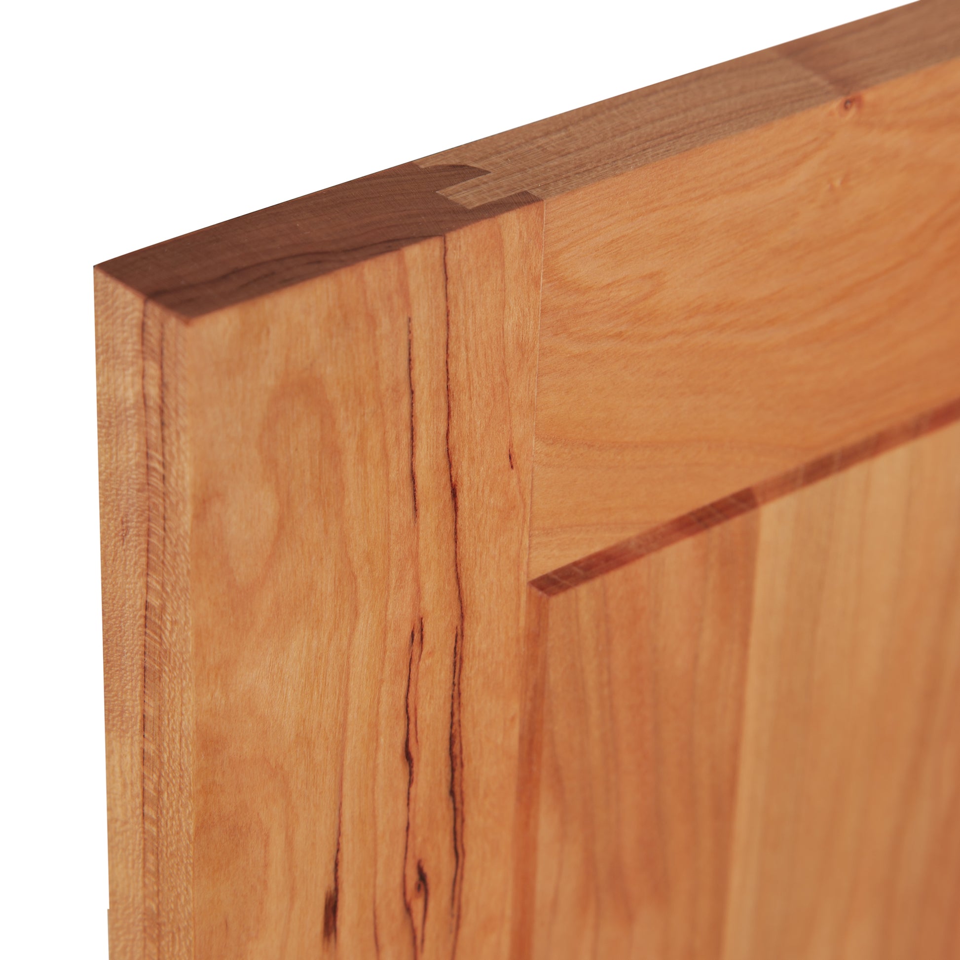 A close-up of an American Shaker Medium Sideboard door corner from Maple Corner Woodworks, highlighting the natural grain and expertly crafted dovetail joint. The sideboard is made from solid hardwood with a light, warm tone and visible texture, exemplifying the craftsmanship and attention to detail synonymous with Vermont artisans.