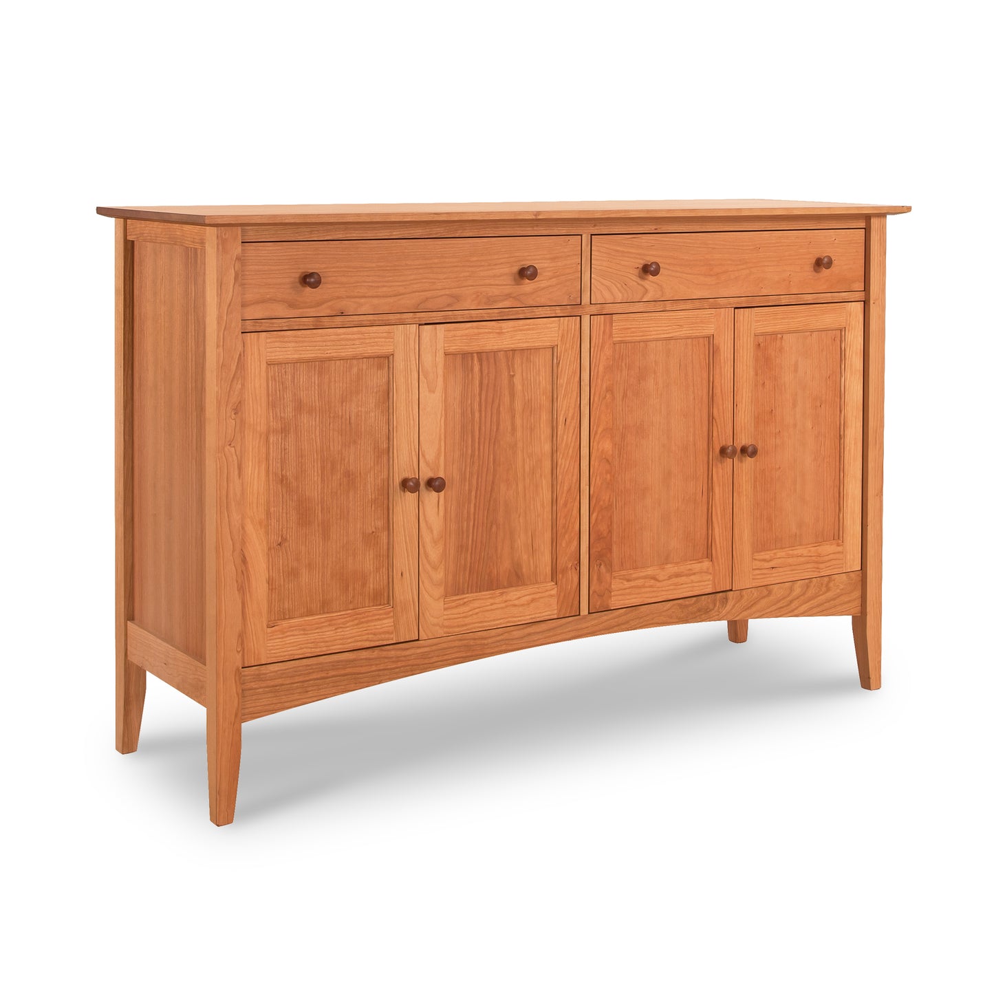 The American Shaker Large Sideboard by Maple Corner Woodworks is crafted from solid hardwood and features two drawers and four cabinet doors in a simple, classic design. It boasts a light, natural wood finish, highlighted by round knobs that emphasize its traditional American Shaker Furniture style.