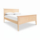 American Shaker Panel Bed by Maple Corner Woodworks with white bedding, featuring fine craftsmanship and classic panel design.