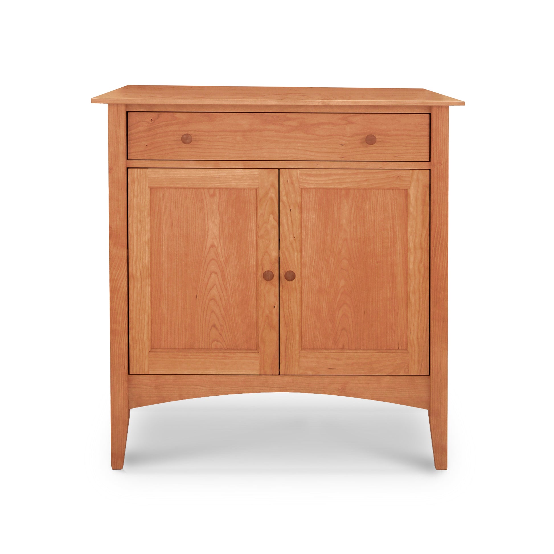 Maple Corner Woodworks' American Shaker Small Sideboard, crafted in Vermont from solid hardwood, features a single top drawer and two doors below. With its natural wood finish, this piece stands gracefully on four short legs, capturing timeless elegance.