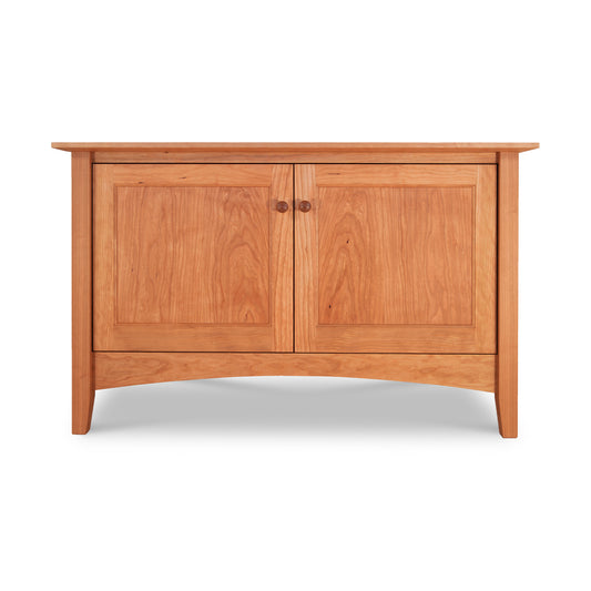 A sustainable American Shaker 48" TV Stand with two closed doors and a flat top, featuring a smooth finish and subtly curved legs, isolated against a white background by Maple Corner Woodworks.