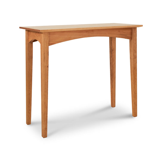 Alt text: American Shaker Sofa Table by Maple Corner Woodworks. This minimalist solid wood table features a rectangular top, four straight legs, and an elegant arch between the legs. Made from eco-friendly light-colored wood and inspired by classic Shaker design, it exemplifies high-quality Vermont-made furniture. Set against a plain white background.
