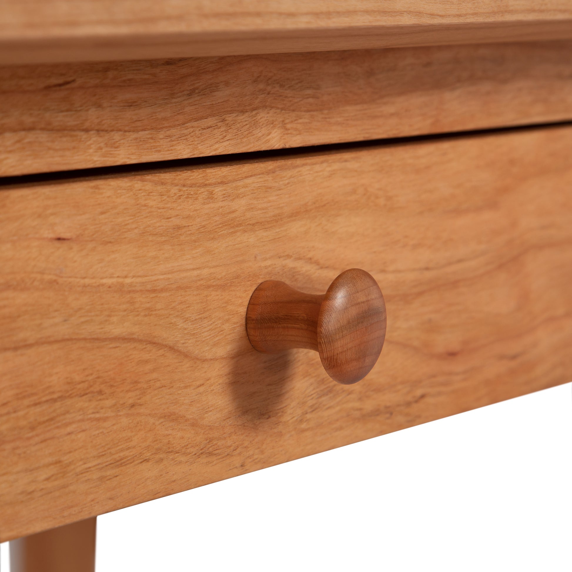Close-up of a wooden drawer with a round knob on a Maple Corner Woodworks American Shaker Writing Desk.