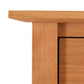 Detailed close-up of the smooth light brown wood grain on the top left corner of Maple Corner Woodworks American Shaker 7-Drawer Dresser.