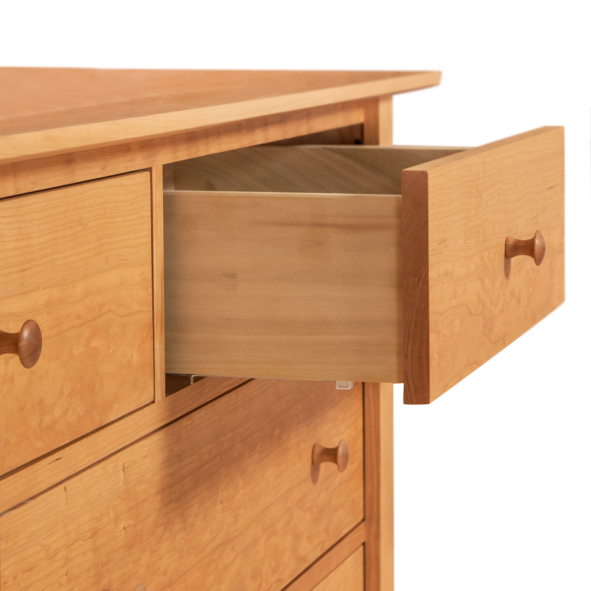 Shaker 7-Drawer Dresser by Maple Corner Woodworks has round knobs, a partially open top drawer, and showcases Vermont craftsmanship.