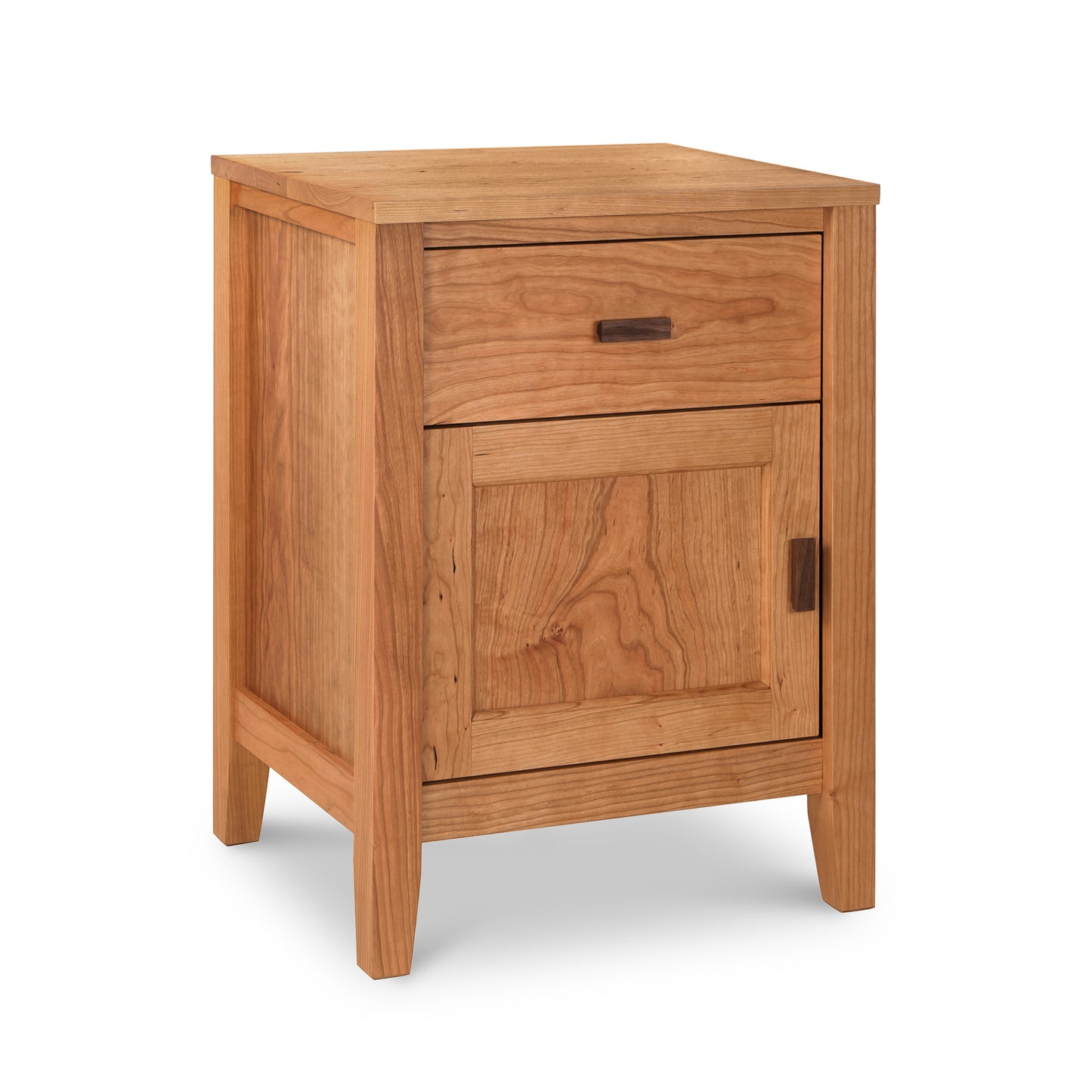 The Maple Corner Woodworks Andover Modern 1-Drawer Nightstand with Door is a small wooden nightstand made from sustainably sourced hardwoods.