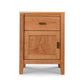 A Maple Corner Woodworks Andover Modern 1-Drawer Nightstand with Door, designed by Vermont woodworkers, featuring a single drawer and a cabinet door, made of sustainable hardwoods with visible wood grain patterns, against a white background.