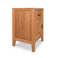 The Maple Corner Woodworks Andover Modern 1-Drawer Nightstand with Door is a small wooden nightstand crafted from sustainably sourced hardwoods.