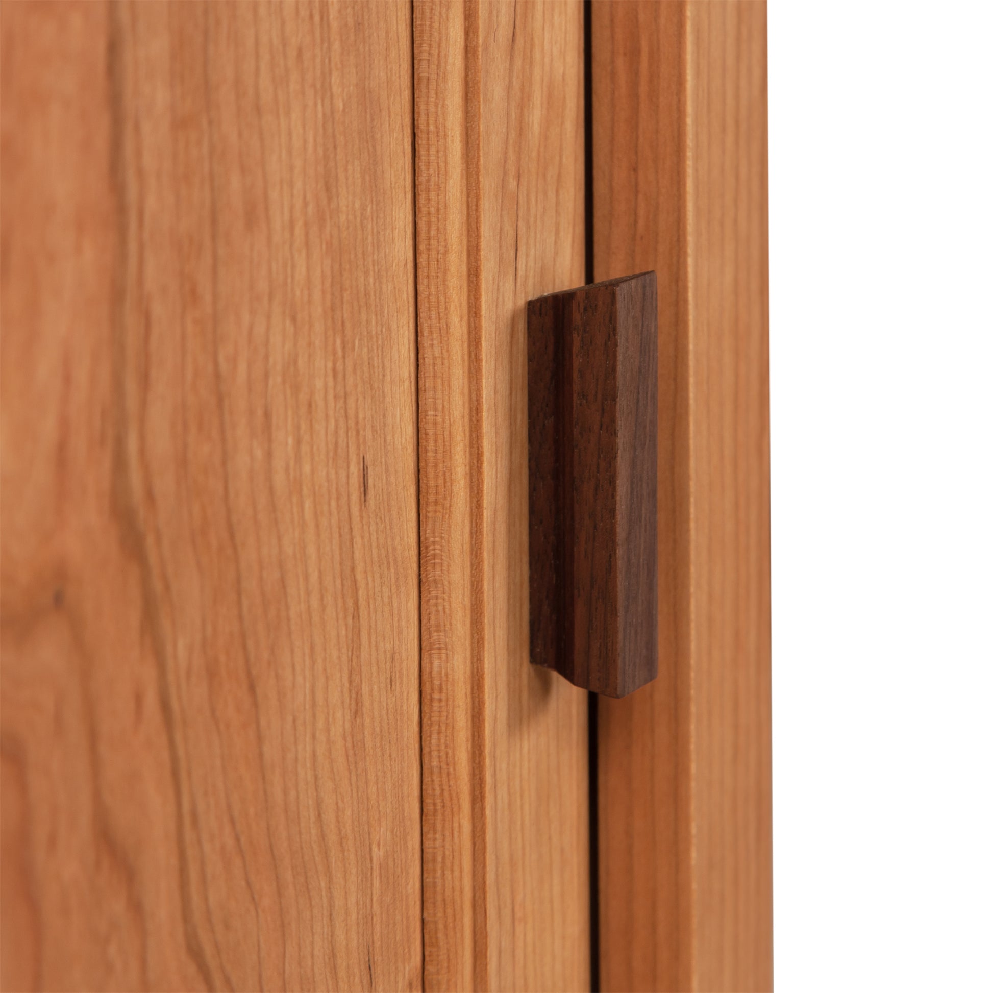 A close up of a Maple Corner Woodworks Andover Modern 1-Drawer Nightstand with Door wooden door handle.