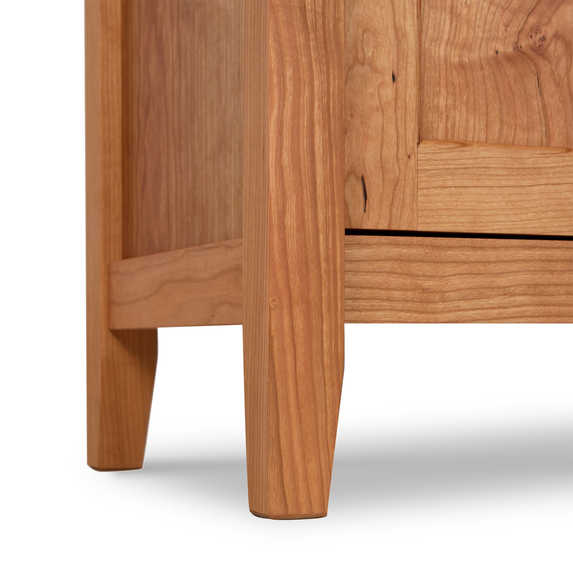 Close-up of a Maple Corner Woodworks Andover Modern 1-Drawer Nightstand with Door detail, crafted by Vermont woodworkers, displaying the joinery and natural wood grain, on a white background.