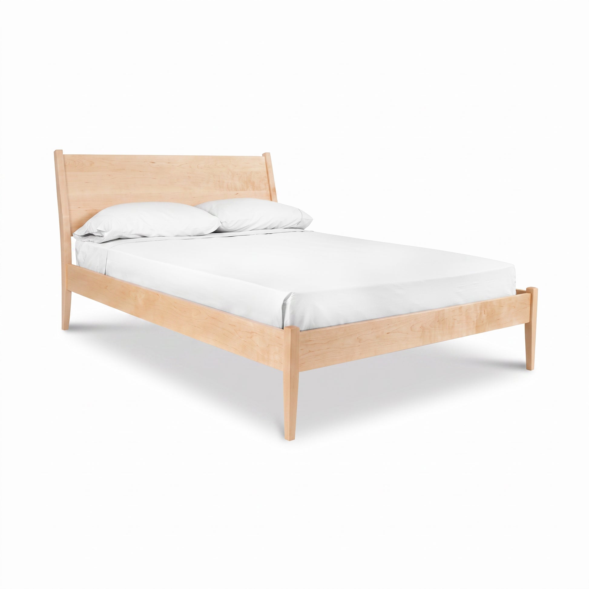Andover Modern Incline Bed by Maple Corner Woodworks, solid wood with an angled headboard, shown with pillows and a white sheet.
