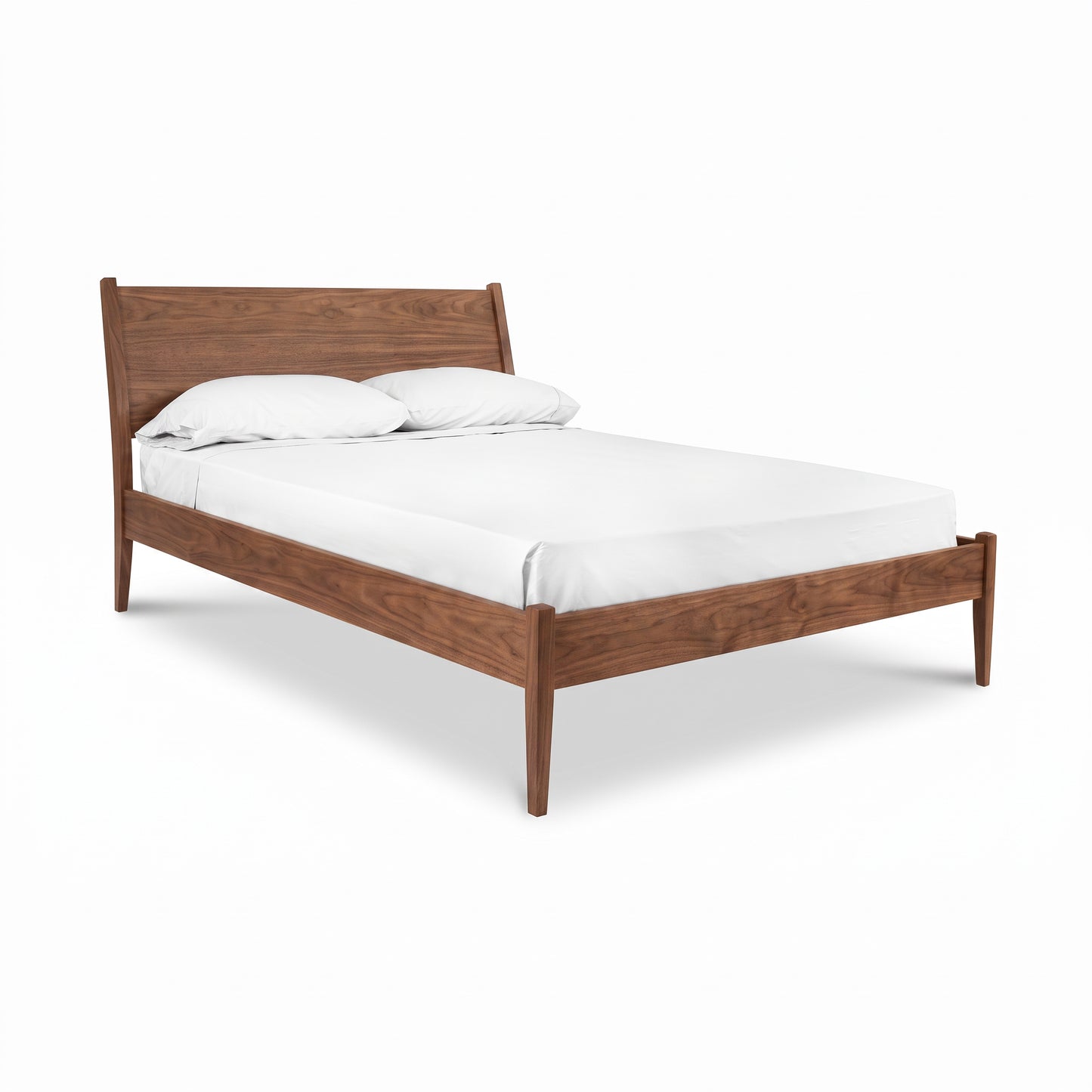 A mid-century modern wooden bed frame with a warm walnut wood, shown with a white mattress and two white pillows on a clean white background.