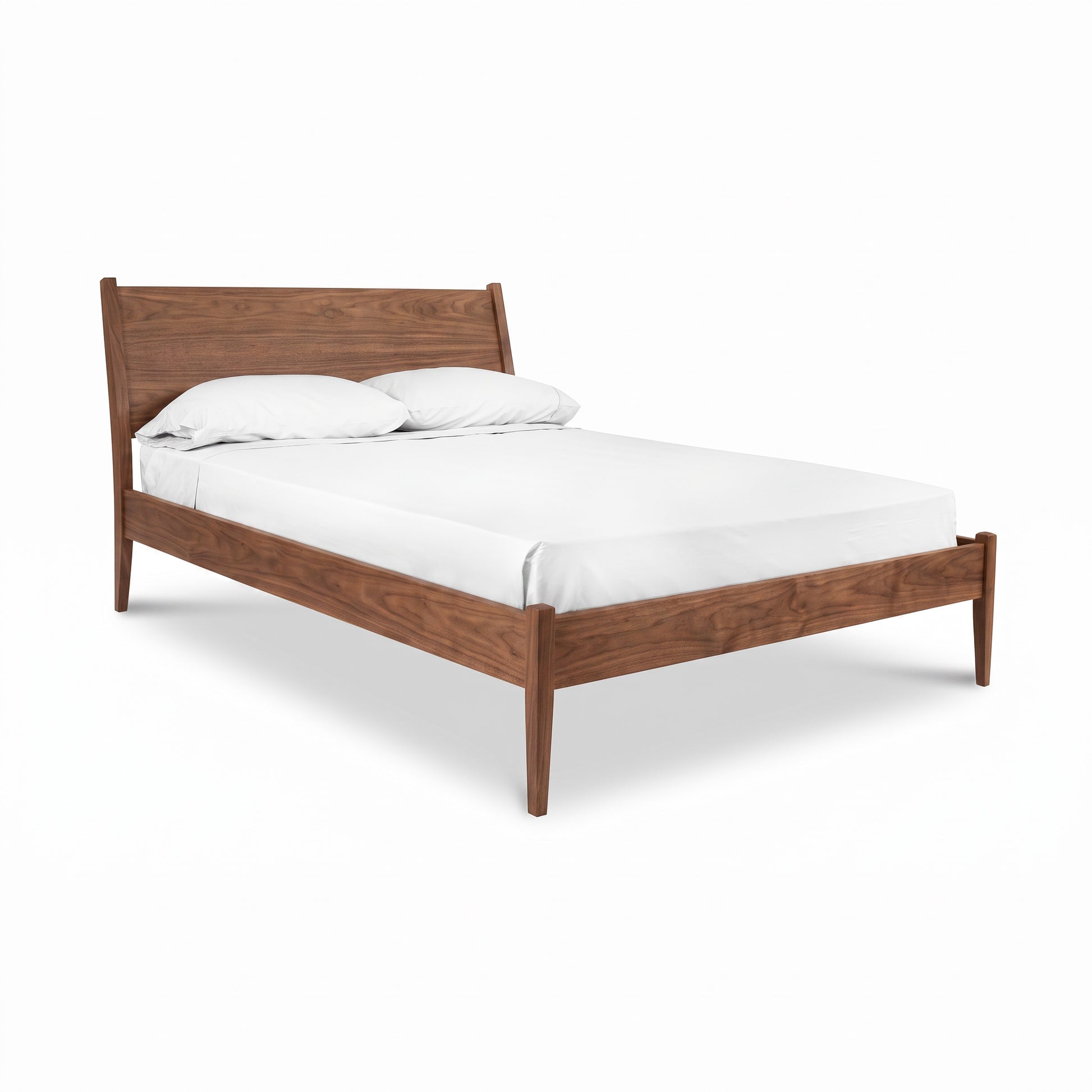 A mid-century modern wooden bed frame with a warm walnut wood, shown with a white mattress and two white pillows on a clean white background.