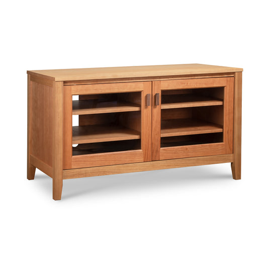 Andover Modern 45" TV Stand by Maple Corner Woodworks features elegant glass doors, three shelves, and a handcrafted light brown wood finish.