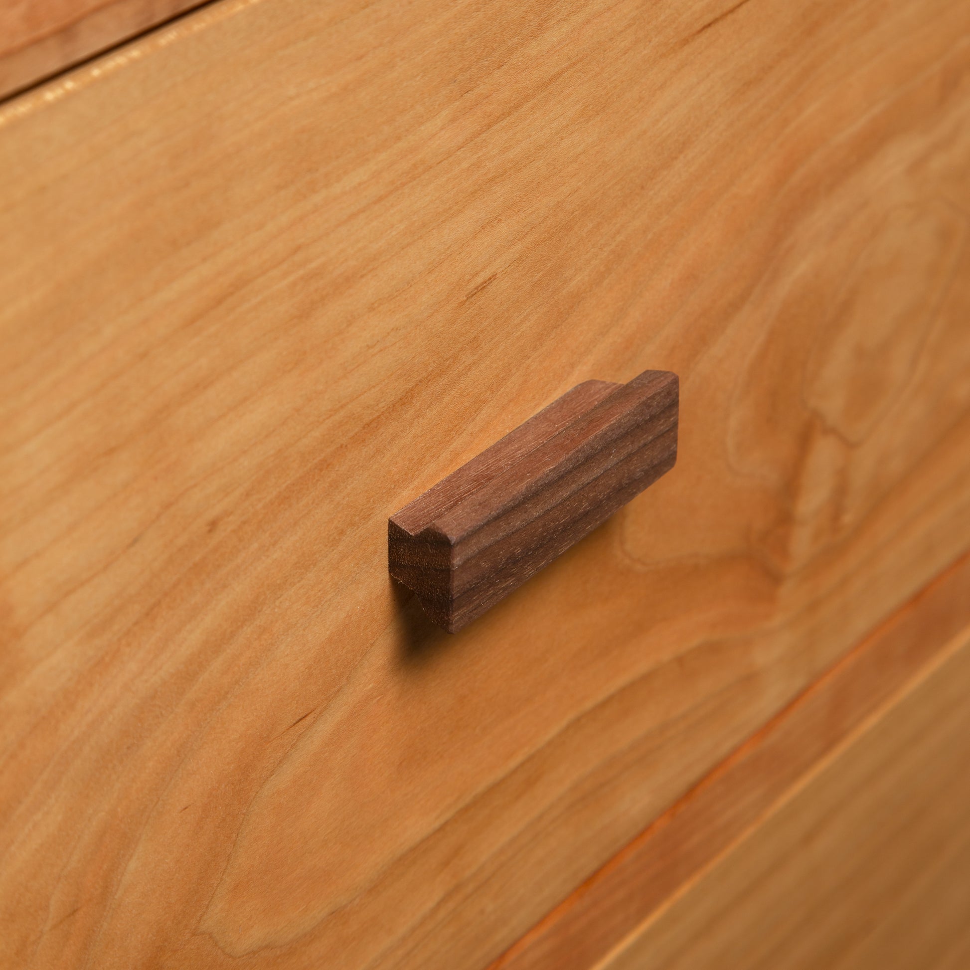 Detail of the Andover Modern Sweater Chest drawer by Maple Corner Woodworks, showcasing the quality wood craftsmanship and sleek rectangular pull.