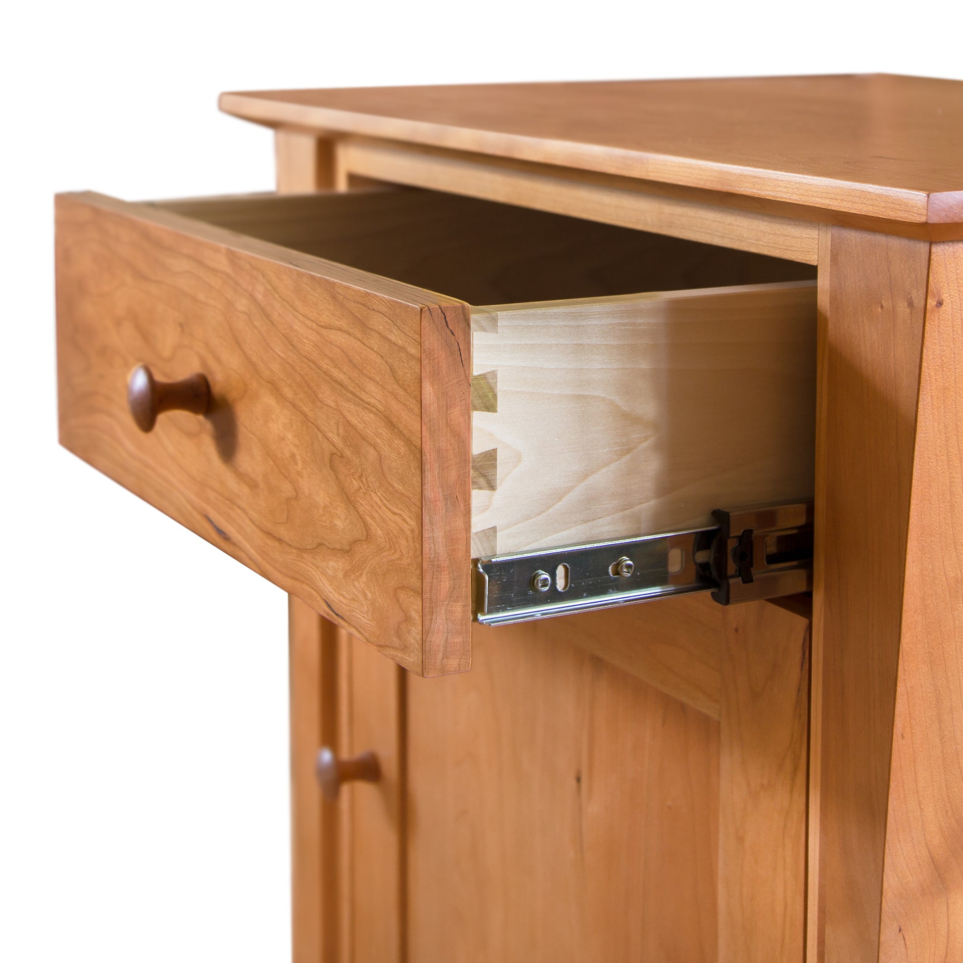 A Lyndon Furniture Andrews 1-Drawer Nightstand with Door is open on a wooden nightstand.