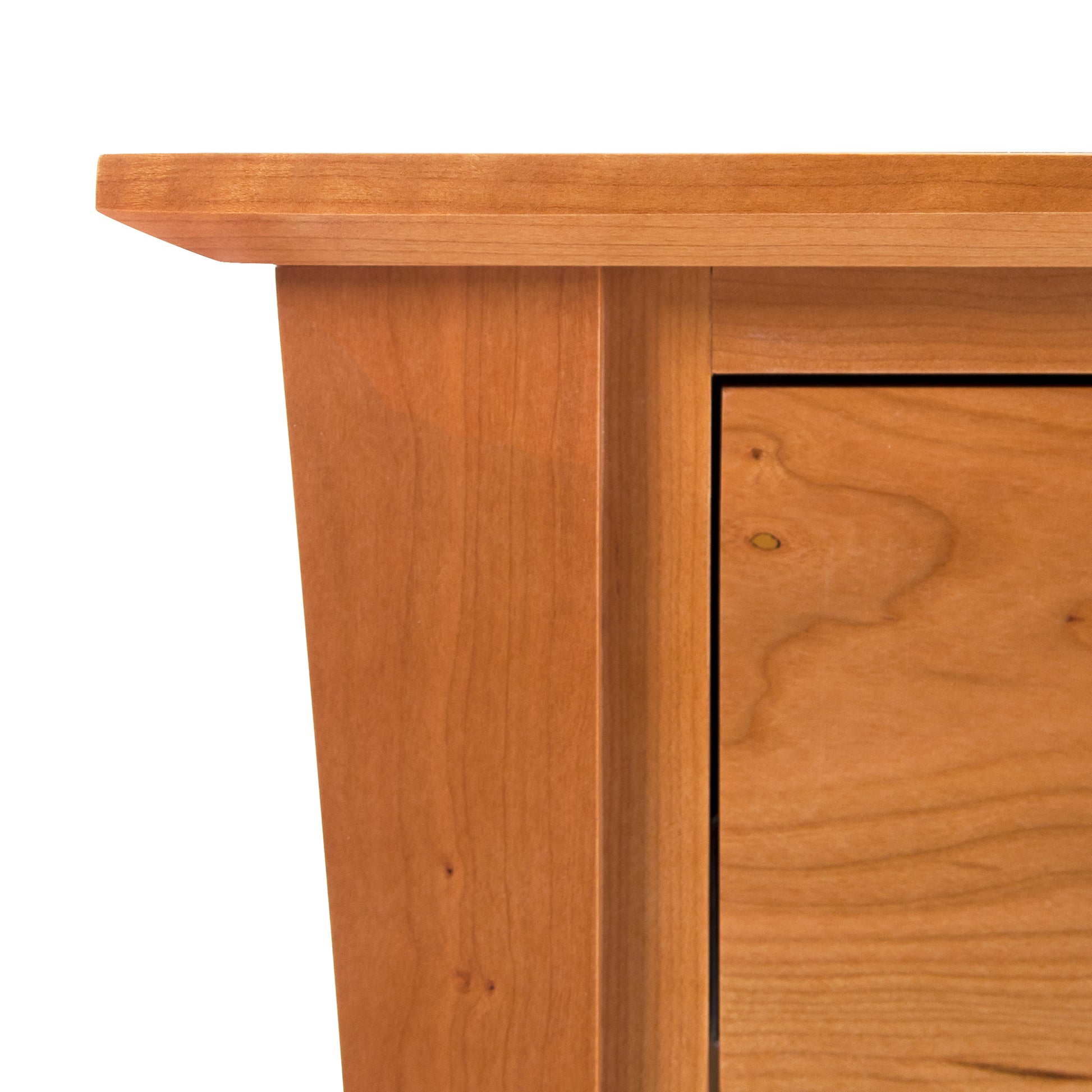 A close up image of a Lyndon Furniture Andrews 3-Drawer Nightstand with storage capabilities.