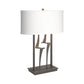 Antasia #1 Table Lamp by Hubbardton Forge featuring a sculptural metal base and white shade, showcasing a handcrafted modern design.