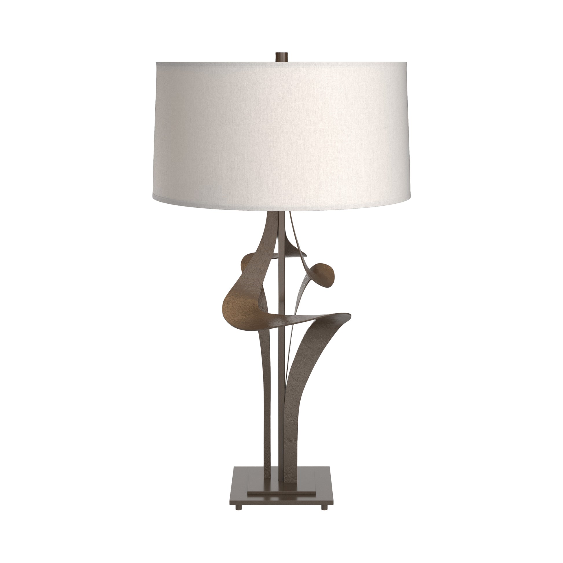 Antasia #2 Table Lamp by Hubbardton Forge with a sculptural bronze base and white cylindrical shade, highlighting elegant, artisan-crafted design.