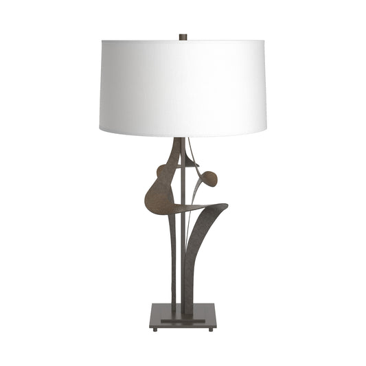Antasia #2 Table Lamp by Hubbardton Forge with sculptural dark smoke metal base and natural Anna shade, crafted in a distinctive square design.