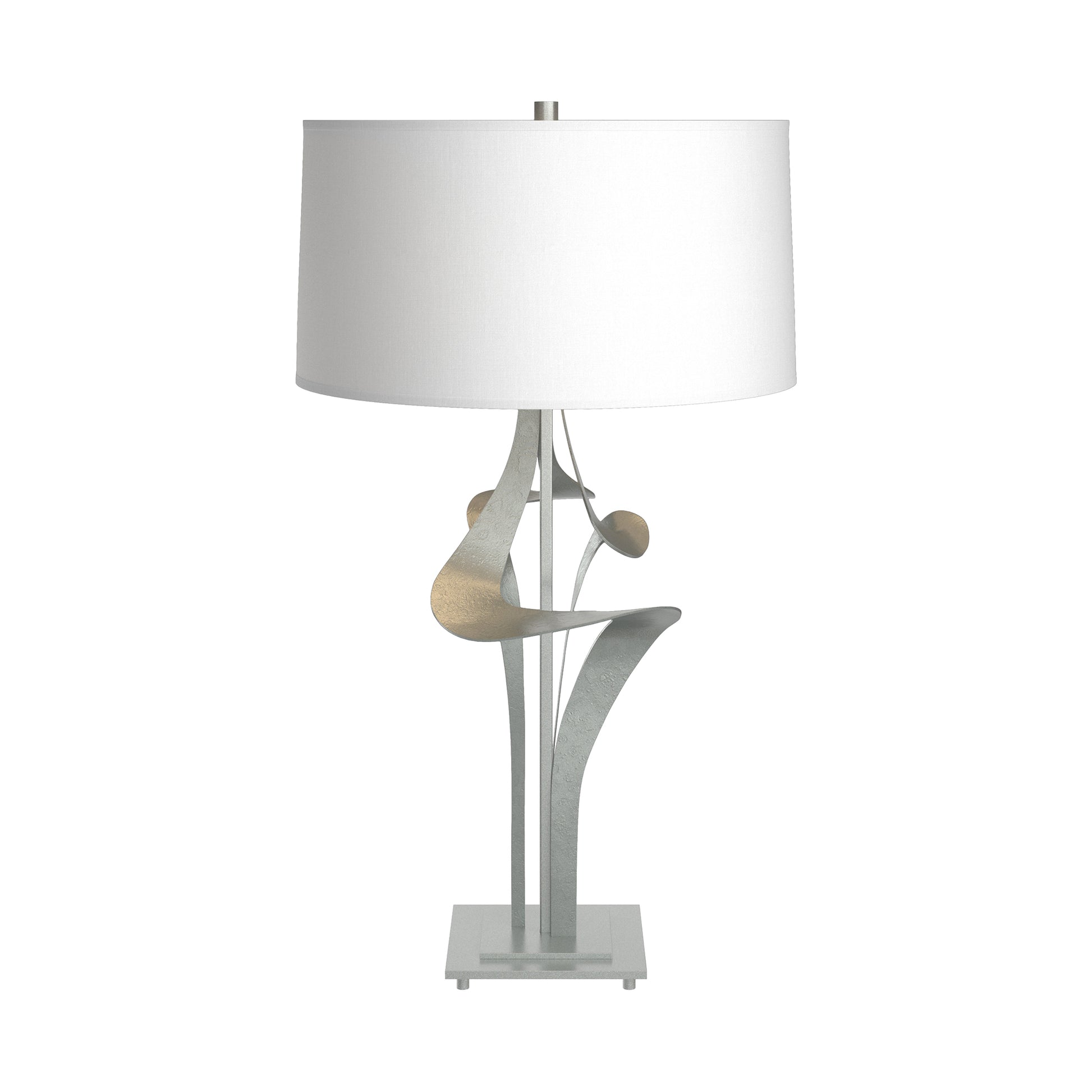 Antasia #2 Table Lamp by Hubbardton Forge with a sculptural metallic base and white drum shade, showcasing modern artisan craftsmanship.