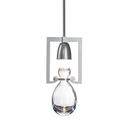 Hubbardton Forge Apothecary Mini Pendant lamp with industrial steel housing and hand-blown clear glass teardrop shade, showcasing elegant craftsmanship.