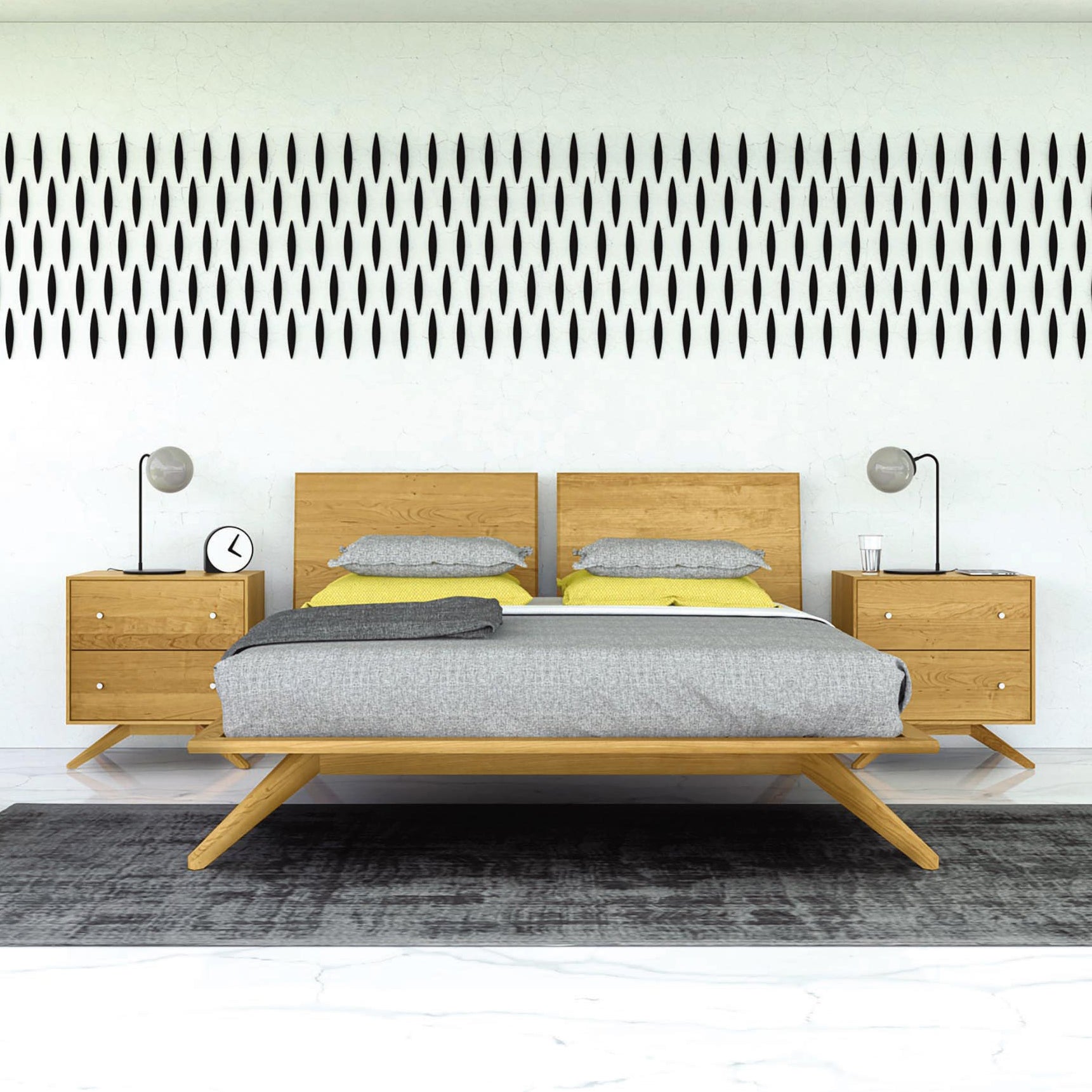 A high-end contemporary bedroom with Scandinavian design, featuring a wooden double bed adorned with gray and yellow bedding. Each side houses a Copeland Furniture Astrid 2-Drawer Nightstand, topped with a lamp, clock, and glass. The wall behind the bed showcases vertical black oval shapes, and a gray rug lies on the floor.