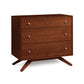 The Copeland Furniture Astrid 3-Drawer Chest is a small chest of drawers with legs made from sustainable hardwood. It is showcased on a white background.