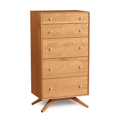 A contemporary design Copeland Furniture Astrid Cherry 5-Drawer Chest, crafted from solid cherry hardwood, on angled legs, isolated on a white background.