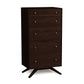 A dark brown solid cherry hardwood Astrid 5-Drawer Chest with angled legs on a white background by Copeland Furniture.