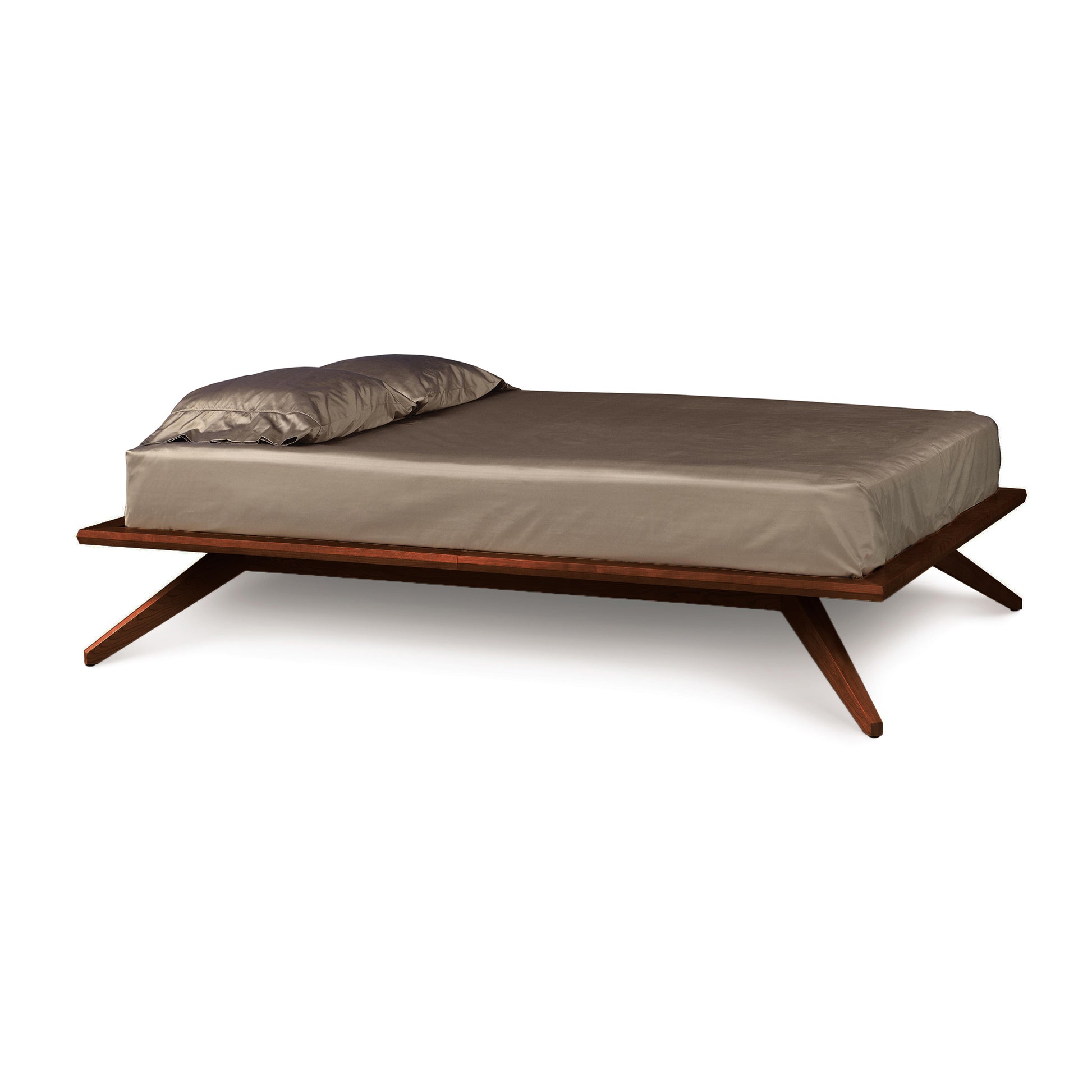 Astrid Platform Bed by Copeland Furniture featuring angled wooden design, beige mattress and pillow, showcasing mid-century modern style.