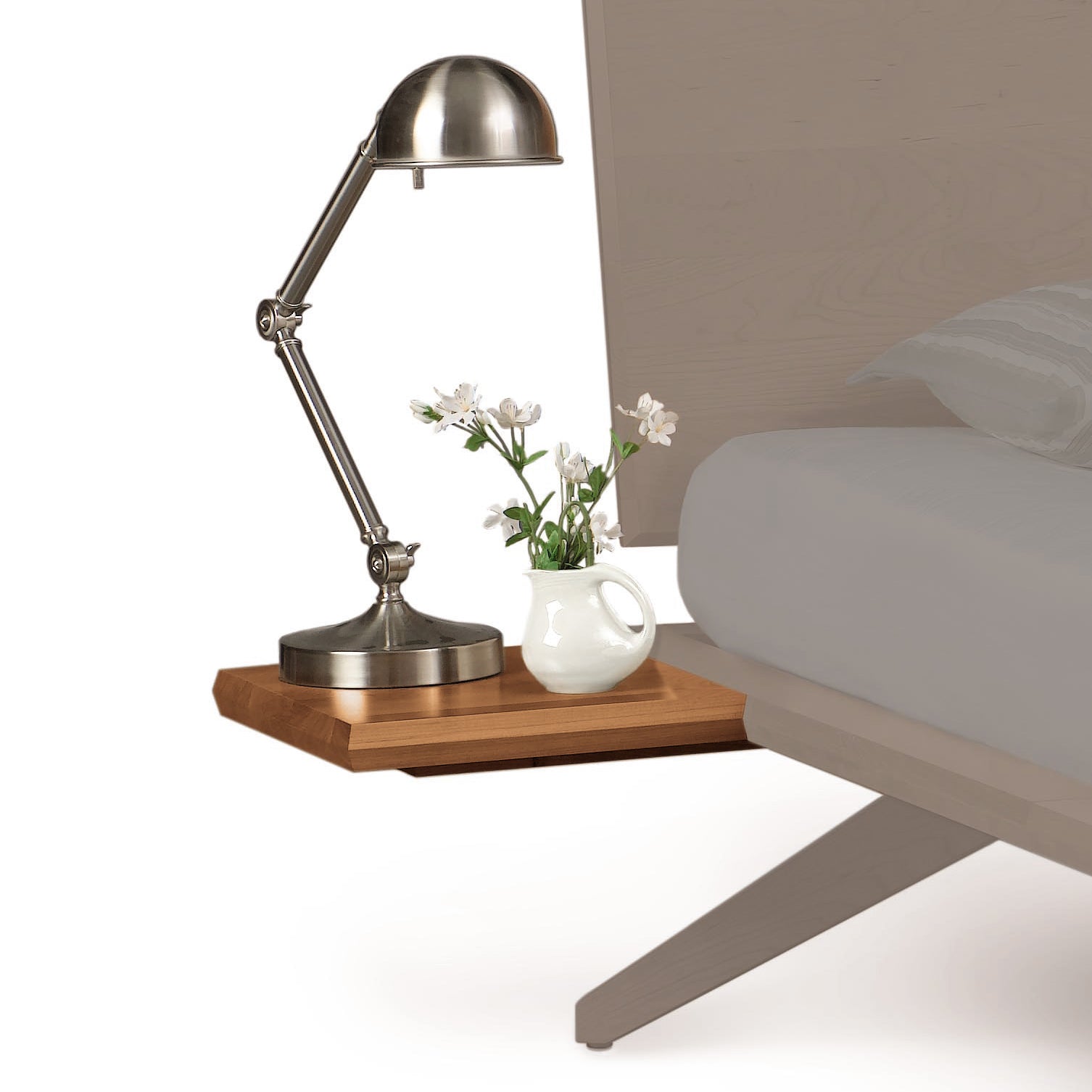 A minimalist style desk lamp with an adjustable arm is positioned on a Copeland Furniture Astrid Shelf Nightstand next to a small white vase with fresh flowers.