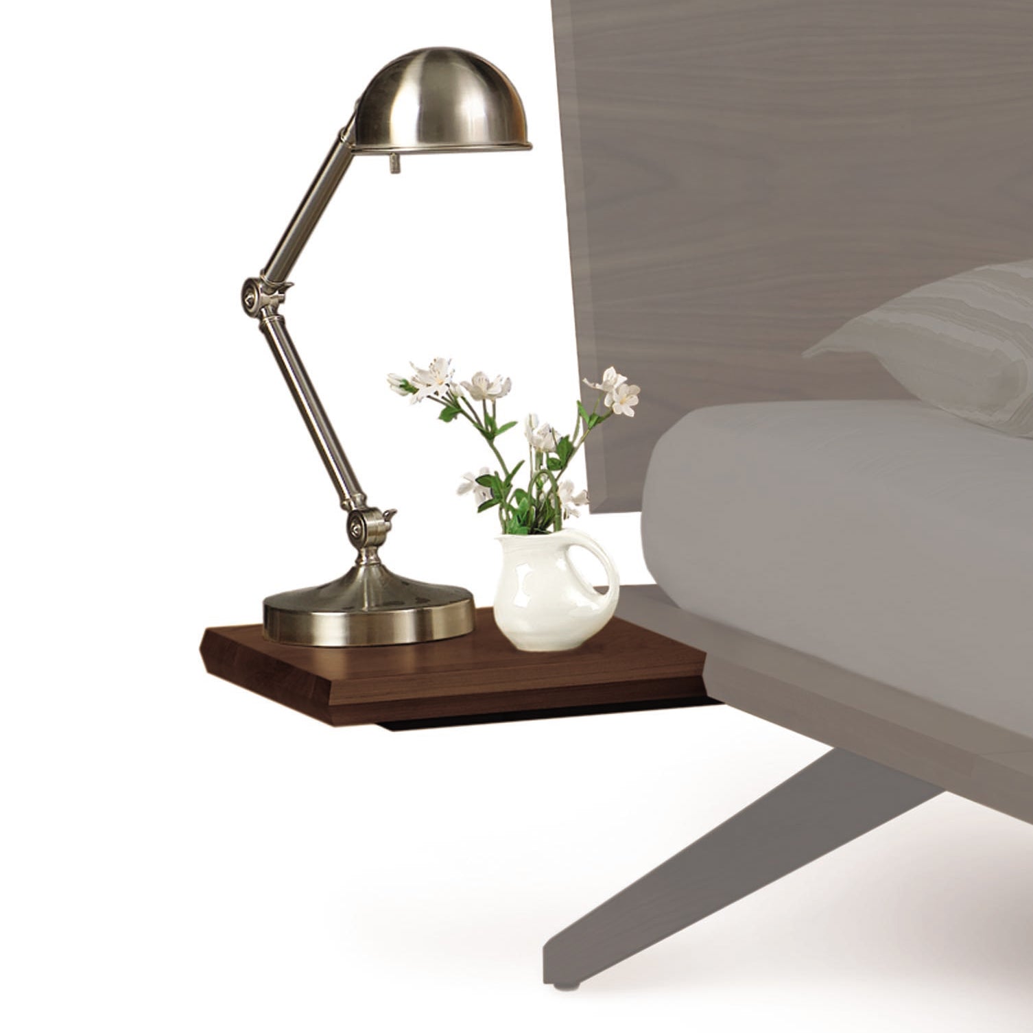 A brass desk lamp sits on a Copeland Furniture Astrid Shelf Nightstand next to a small white vase with flowers in a minimalist style.